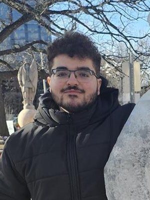 A student standing outside in cold weather.